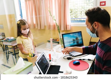 Student With A Mask Handing Over Homework To The Teacher Through A Screen