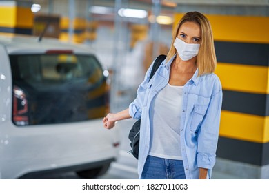 Student In Mask Leaving Car In Underground Parking Lot