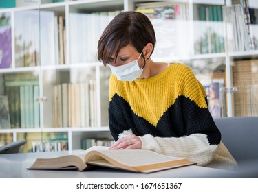 Student With Medicine Protective Mask Reading A Book In Library. Business Woman Wear Mask To Protect And Take Care Of Their Health.