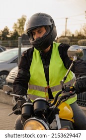 A Student Of A Motorcycle School In A Training Vest Is Having A Driving Lesson. Motorcyclist In A Helmet And Gear. Riding A Motorcycle. Motorcycle Power.