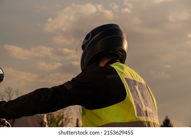 A Student Of A Motorcycle School In A Training Vest Is Having A Driving Lesson. Motorcyclist In A Helmet And Gear. Riding A Motorcycle. Motorcycle Power.