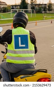 A Student Of A Motorcycle School In A Training Vest Is Having A Driving Lesson. Motorcyclist In A Helmet And Gear. Riding A Motorcycle. Motorcycle Power.