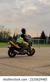 A Student Of A Motorcycle School In A Training Vest Is Having A Driving Lesson. Motorcyclist In A Helmet And Gear. Riding A Motorcycle. Motorcycle Power.