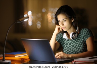 Student in the night e-learning using laptop at home