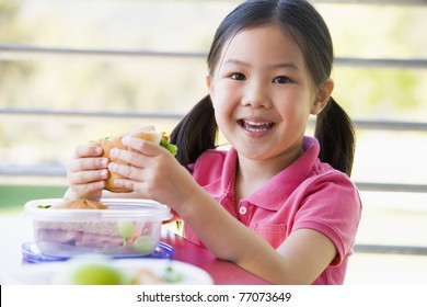 Student Outdoors Eating Lunch (selective Focus)