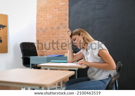 Student passing difficult exam at school
