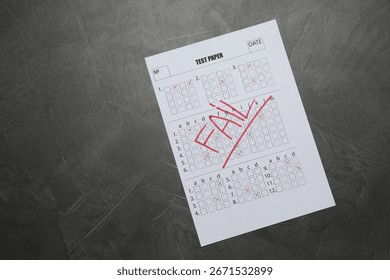 Student passing exam. Answer sheet with word Fail on gray textured table, top view. Space for text