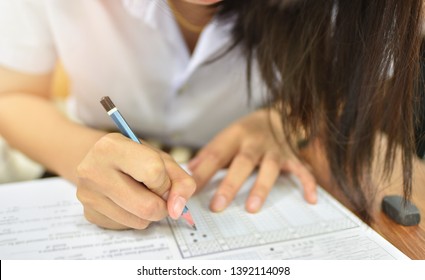 Student With A Pencil Taking Final Test In The Examination Room - Educational Or Academic Concept Image Of Test Taker In The Training Or Learning Room At Collage Of University Campus, Selective Focus