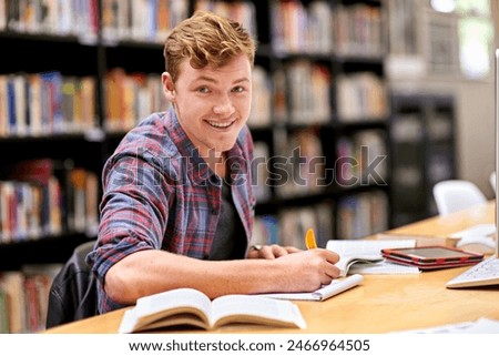 Student, portrait and notebook in library for study, education and university quiz with pen on table. Man, happy and books on school campus for college exam, research and learning with scholarship