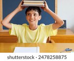 student, preteen, boy, happy playing with books on his head. back to school concept