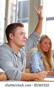 Student Raising His Hand In University Class