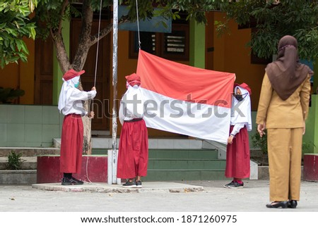 Student raising Indonesian flag in school