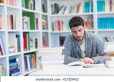 Student Reading Book In Library Study Lessons For  Exam.