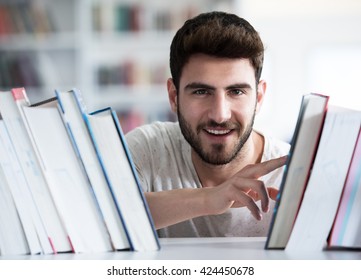 Student reading book in school library. Study lessons for exam. Hard worker and persistance concept. - Shutterstock ID 424450678
