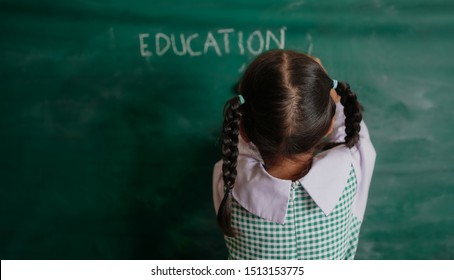 Student Or School Child Girl Writing The On The Blackboard At Classroom.Education Concept.