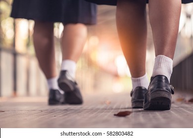 Student shoes walking on the bridge. - Shutterstock ID 582803482