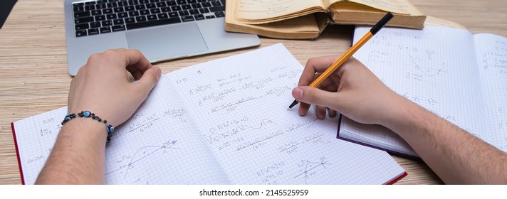 the student solves math problems. Calculating the derivative. Learning advanced mathematics in college - Shutterstock ID 2145525959
