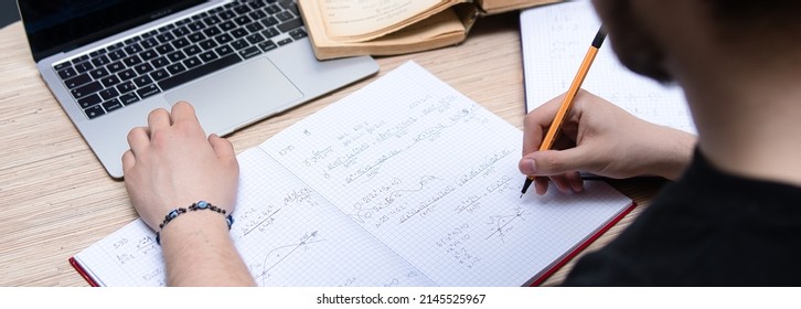 the student solves math problems. Calculating the derivative. Learning advanced mathematics in college