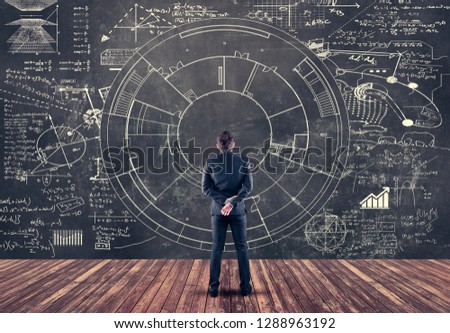 Student solving math formulas drawn on blackboard.