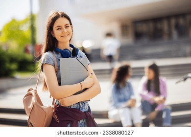 Student standing with her note-book while her friends are studying behind her - Powered by Shutterstock