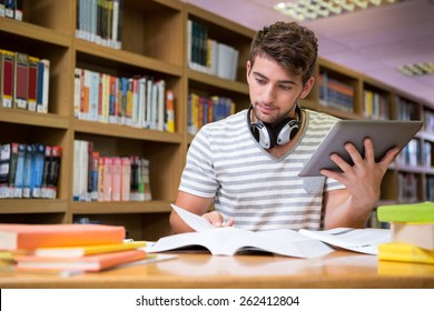 Student Studying In The Library With Tablet At The University