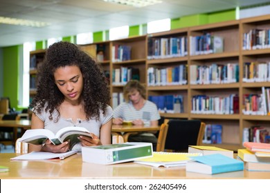 Student Studying In The Library At The University