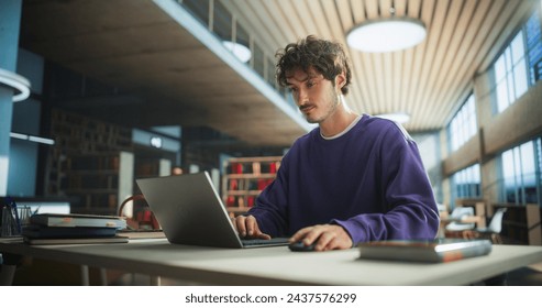 Student Studying in a Modern Library. Young Man Thinking and Problem Solving School Exercises. Male Using Laptop Computer to Work on a University Research Project Online - Powered by Shutterstock