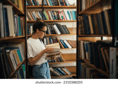 A student stuying and reading books in a public library of university. - Powered by Shutterstock