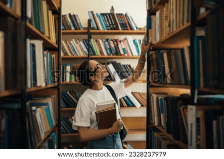 A student stuying and reading books in a public library of university.