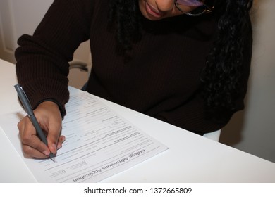 Student Submitting Her Application For College Admission.