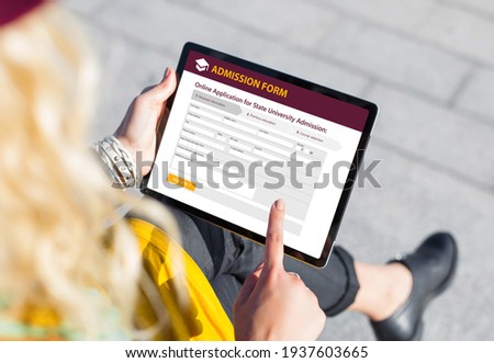 Student submitting online admission form on tablet computer