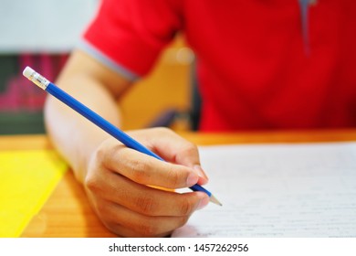 Student Taking Test With A Pencil In The Room Of Testing Center At The College Or University Campus, Selective Focus Picture Of Learner, Education Or Academic Concept, Idea For Professional Studying