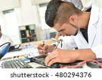 Student in technology fixing computer processing