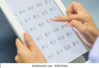 Student Testing Exercise, Exams Answer On Tablet With Multiple Choice Questions By Finger Clicking, Concept Educational Technology Use Physical Hardware, Computer-based, Online Learning Technologies