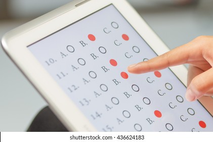 Student Testing Exercise, Exams Answer On Tablet With Multiple Choice Questions By Finger Clicking, Concept Educational Technology Use Physical Hardware, Computer-based, Online Learning Technologies