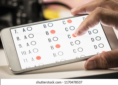 Student Testing Online Learning, E-learning Exam On Smartphone With Multiple Choice Questions By Finger Clicking.Concept Educational Technology Use Laptop Computer By Internet For Everywhere Everytime