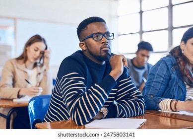 Student, thinking and black man in college classroom for education, test or exam. Idea, university and studying in lecture for problem solving, doubt or brainstorming for learning knowledge at school - Powered by Shutterstock