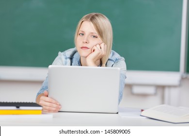 Student trying to solve a problem with laptop