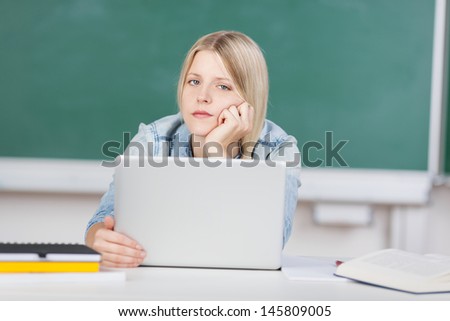 Student trying to solve a problem with laptop