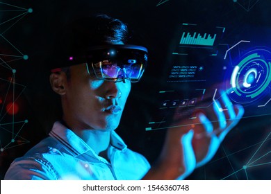 Student Trying Vr Glasses Hololens In The Dark Room. Young Asian Boy Experiences Ar With Control Panel Like Iron Man.