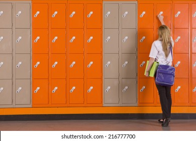Student unlocking school locker Arkistovalokuva