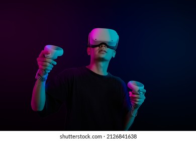 Student Use Vr Glasses And Looks At Empty Space With Gray Background. Virtual Gadgets For Entertainment, Work, Free Time And Study. Game Cyber Virtual Reality Metaverse Technology Concept.