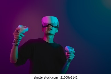 Student Use Vr Glasses And Looks At Empty Space With Gray Background. Virtual Gadgets For Entertainment, Work, Free Time And Study. Game Cyber Virtual Reality Metaverse Technology Concept.