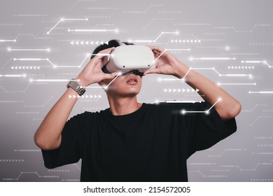 Student Use Vr Glasses And Looks At Empty Space With Gray Background, Studio Shot.Virtual Gadgets For Entertainment, Work, Free Time And Study. Game Cyber Virtual Reality Technology Concept.