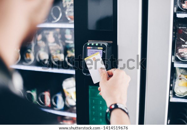 Student using the contactless payment method in\
a vending machine.