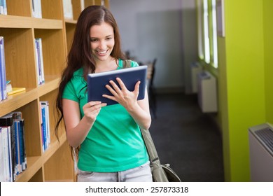 Student using her tablet in library at the university