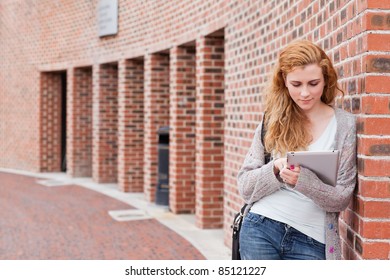 Student Using A Tablet Computer Outside A Building