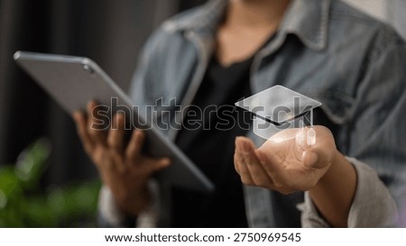 Student using tablet with digital graduation cap icon representing online education, e-learning technology, digital learning platform and modern remote study concept.