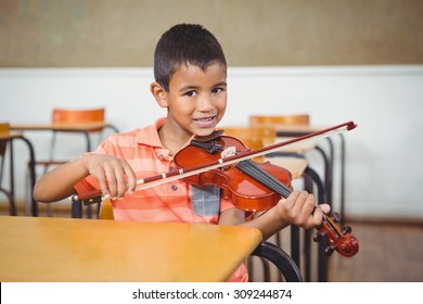 Student Using A Violin In Class At The Elementary School