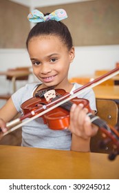 Student Using A Violin In Class At The Elementary School